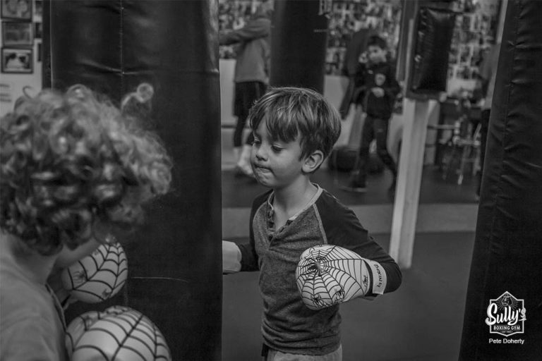 children hitting heavy bags at sullys boxing gym toronto