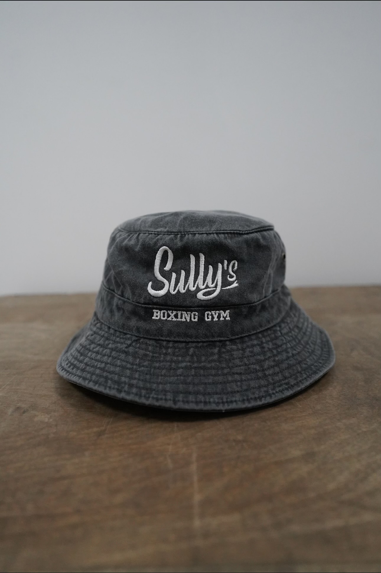 Distressed Bucket Hat with Sully's logo in gray.